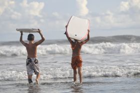 Young men boogie boarding near Coronado, Panama – Best Places In The World To Retire – International Living